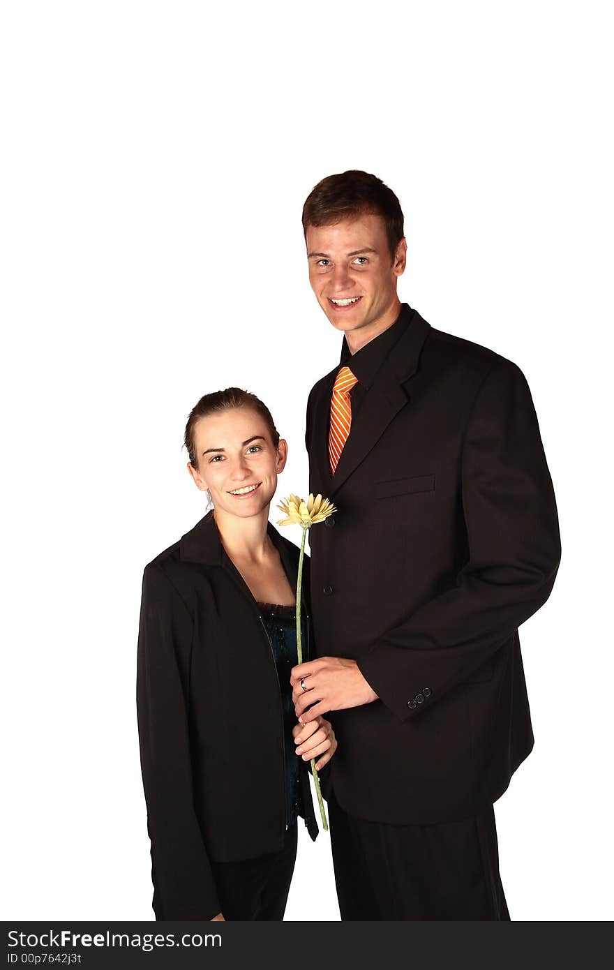 Young couple holding a flower dressed for success