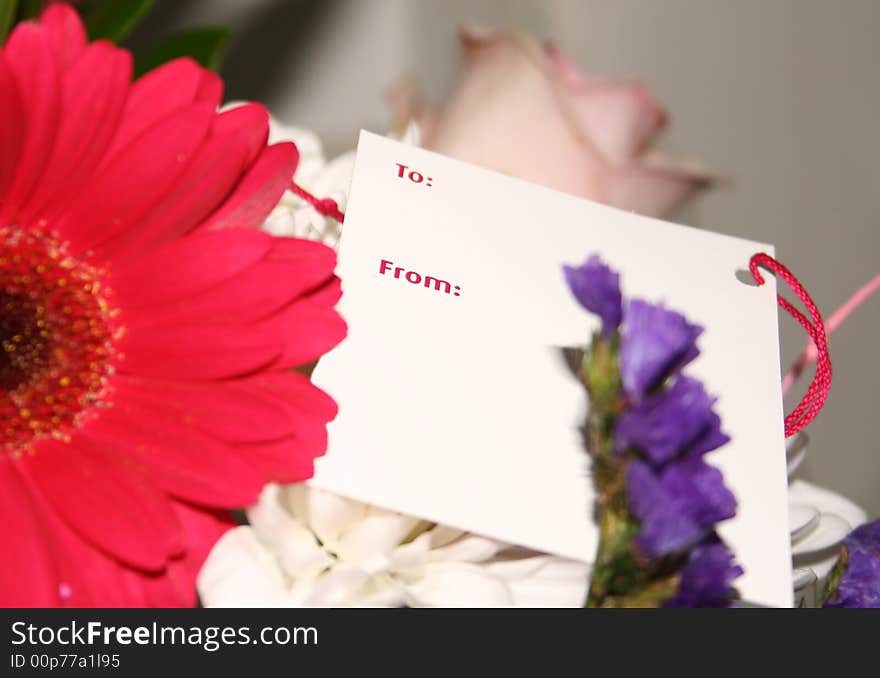 Blank card on a bouquet of flowers. Blank card on a bouquet of flowers