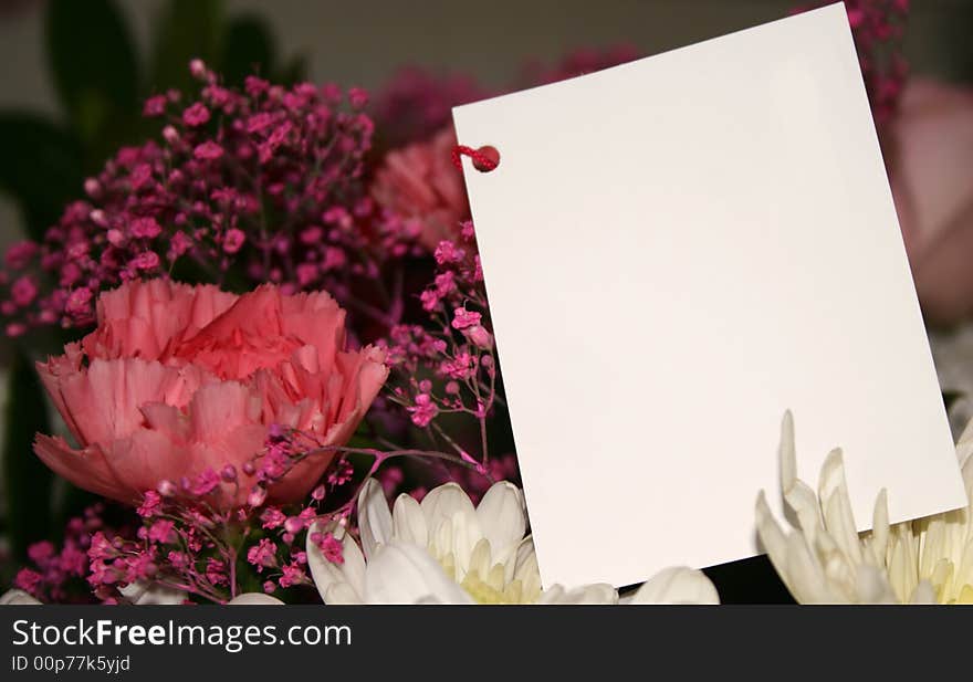 Blank card on a bouquet of flowers. Blank card on a bouquet of flowers