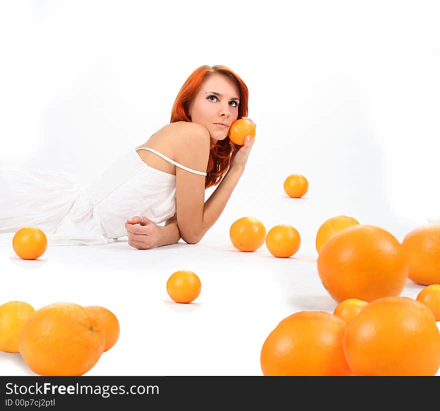 Redhead girl and oranges in studio. Redhead girl and oranges in studio