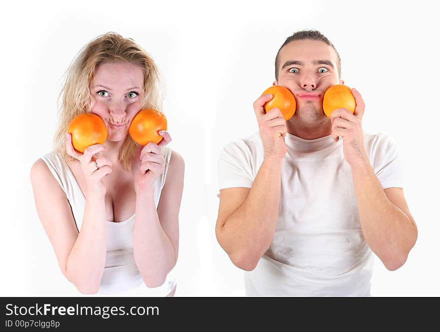 Boy and girl is playing with oranges in studio. Boy and girl is playing with oranges in studio