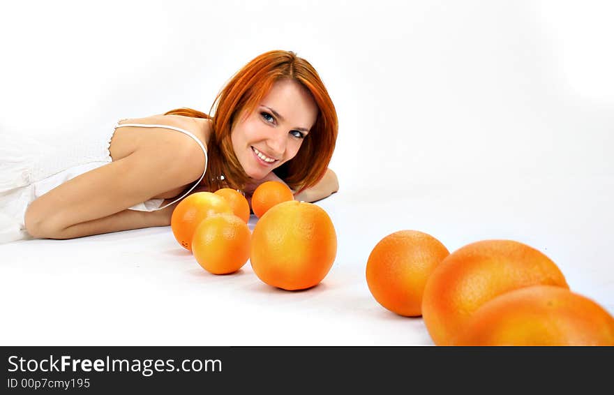 Redhead girl and oranges in studio. Redhead girl and oranges in studio