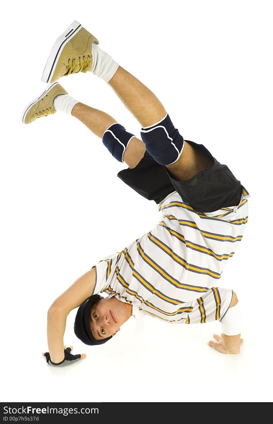 Young bboy standing on hands. Holding legs in air. Looking at camera and smiling. Isolated on white in studio. Front view, whole body. Young bboy standing on hands. Holding legs in air. Looking at camera and smiling. Isolated on white in studio. Front view, whole body