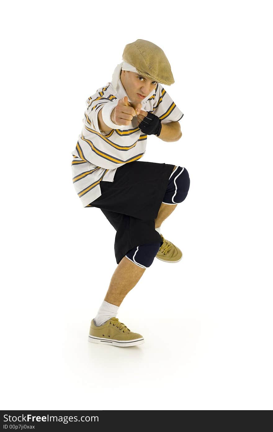 Young, angry bboy standing on one leg. Looking and pointing at camera. Isolated on white in studio. Side view, whole body. Young, angry bboy standing on one leg. Looking and pointing at camera. Isolated on white in studio. Side view, whole body