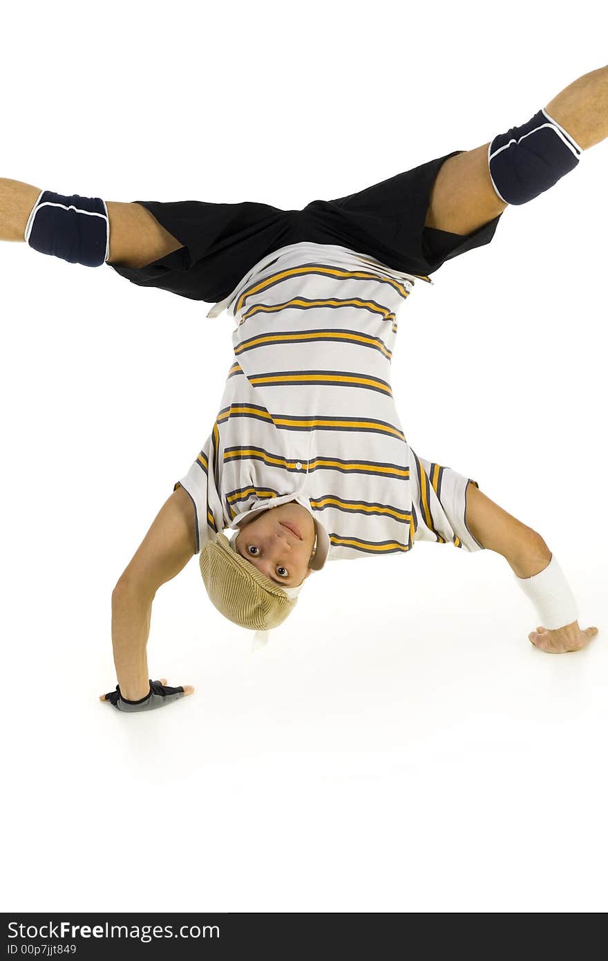 Young bboy standing on hands. Holding legs in air. Looking at camera. Front view, white background. Young bboy standing on hands. Holding legs in air. Looking at camera. Front view, white background