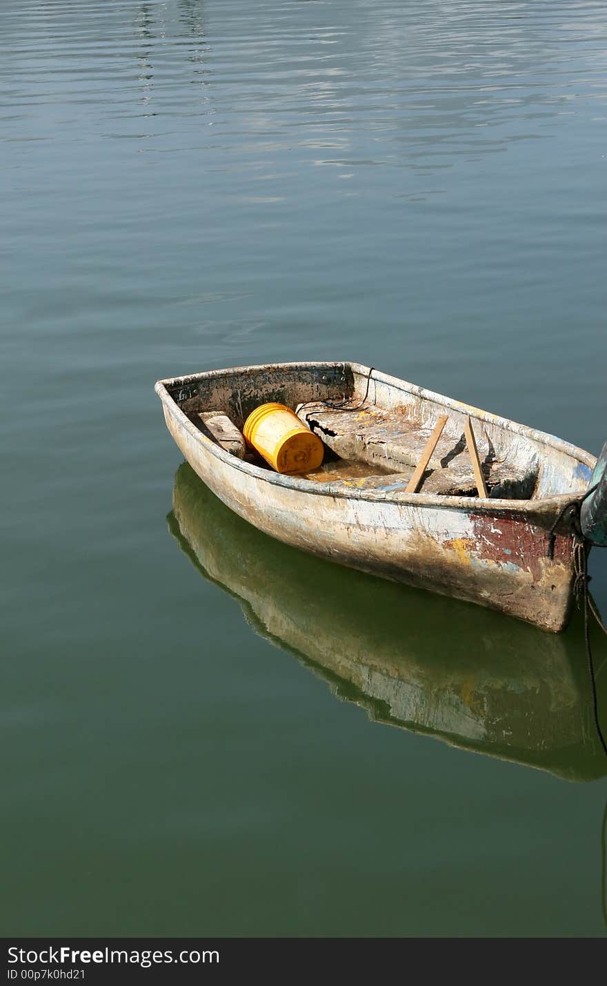 A small dinghy boat bobbing on calm waters