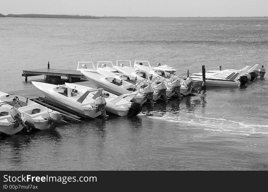 Boats docked at a marina in black and white. Boats docked at a marina in black and white