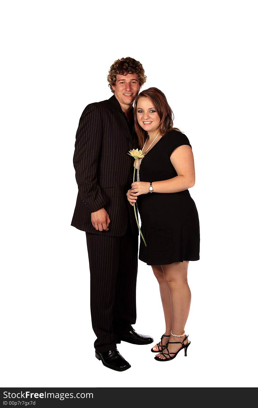 Young couple holding each other with flower in hand. Young couple holding each other with flower in hand