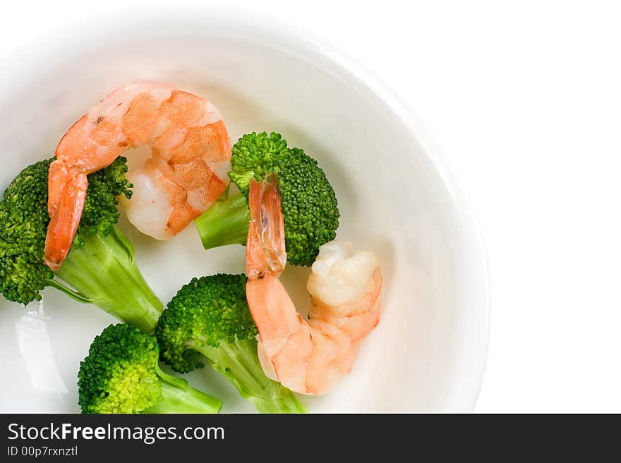 Cooked shrimps and green broccoli florets in a white bowl. Cooked shrimps and green broccoli florets in a white bowl