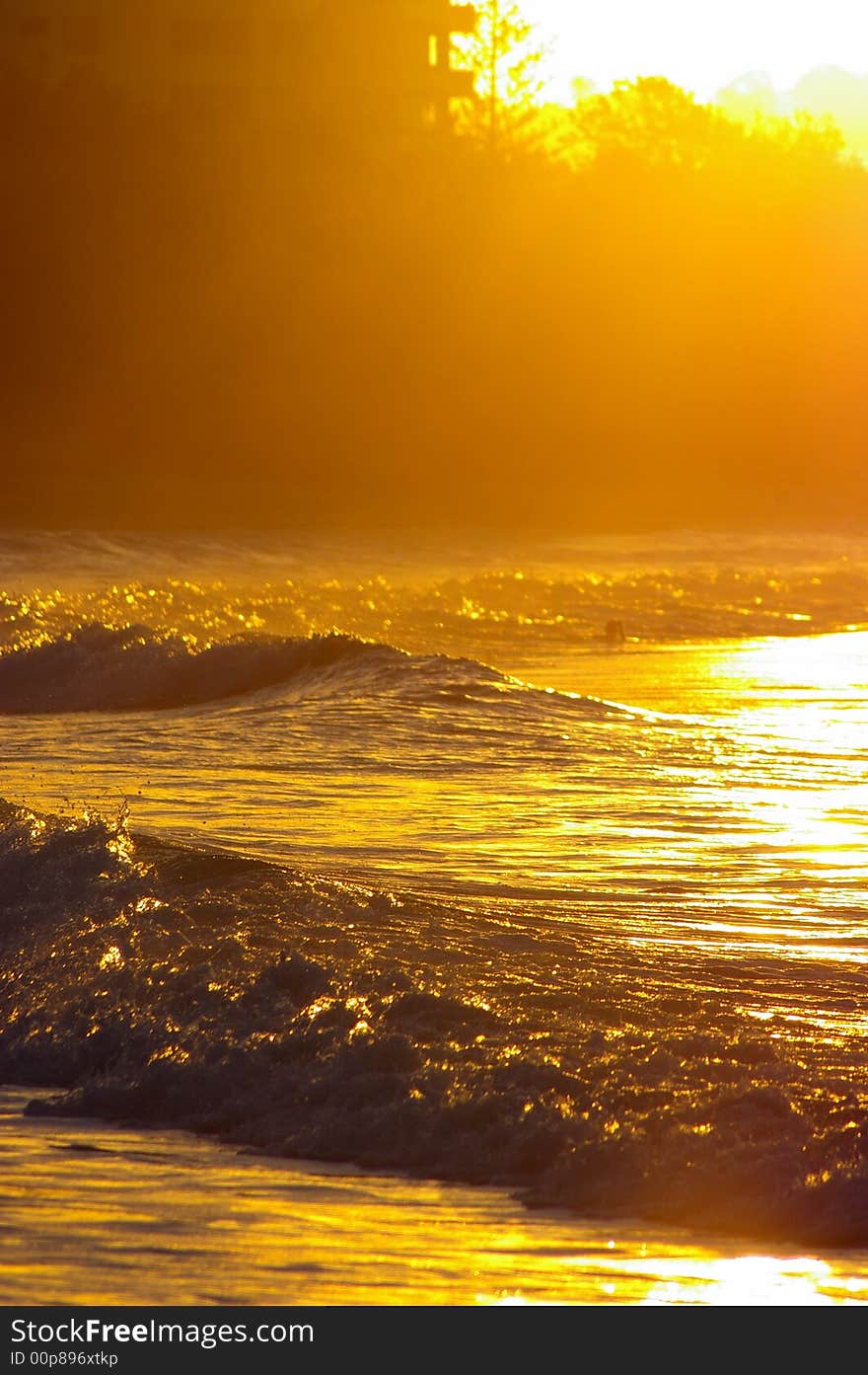 A small set of waves as the tide comes in at a beach on sunset. A small set of waves as the tide comes in at a beach on sunset