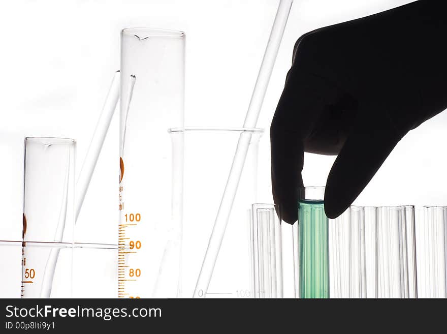 A hand holding a test tube in plain background. A hand holding a test tube in plain background.