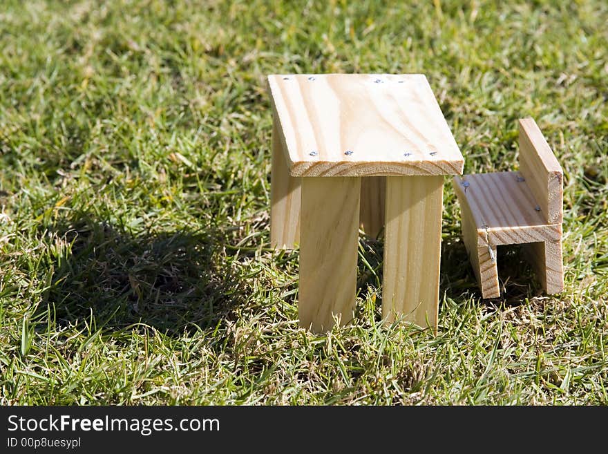 Small table and bench made from wood and self cconstructed as toy furniture... Photographed against nice green grass. Small table and bench made from wood and self cconstructed as toy furniture... Photographed against nice green grass...