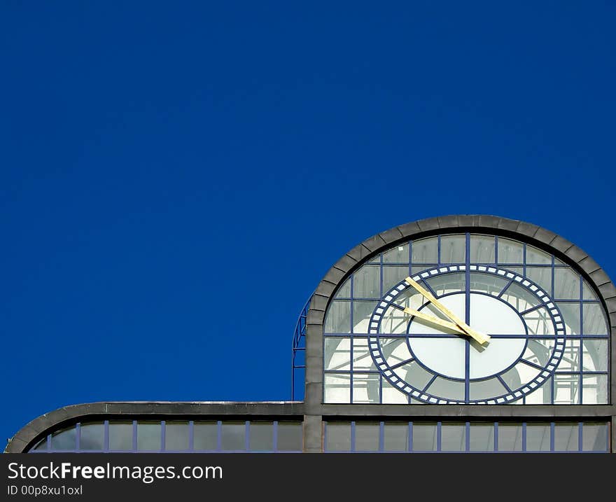 Modern clock tower in Prague against the blue sky