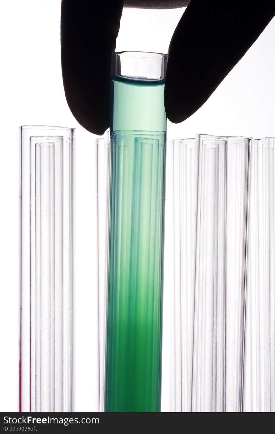 A hand holding a test tube in plain background. A hand holding a test tube in plain background.