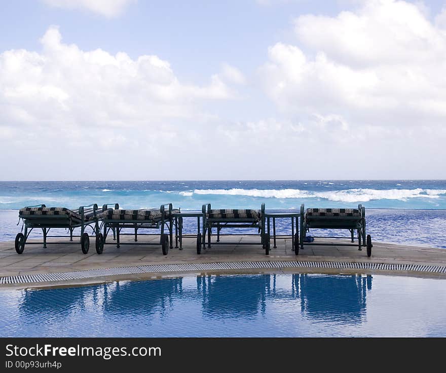 Four Chairs By The Sea