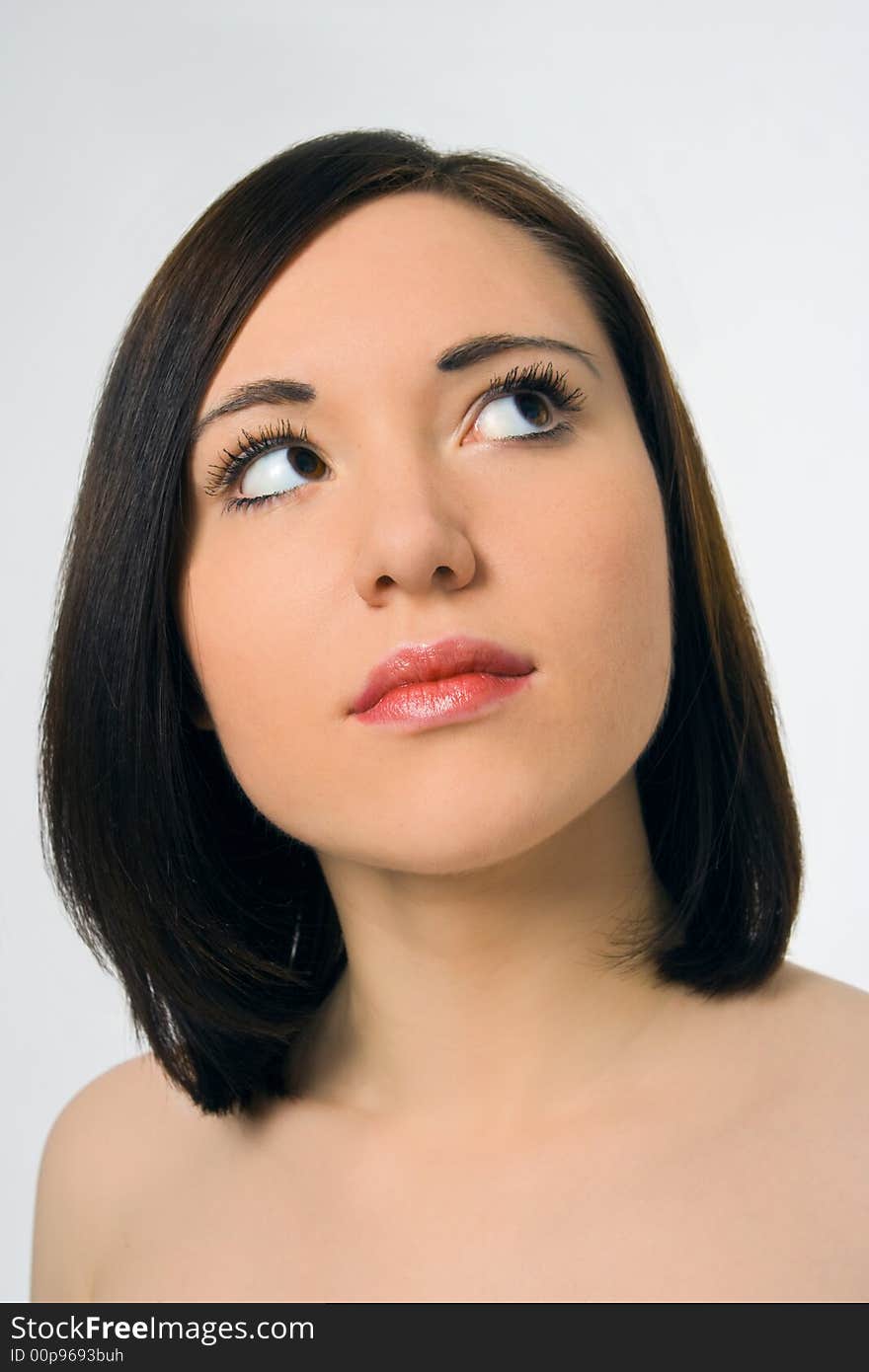 Beautiful young woman portrait on gray background