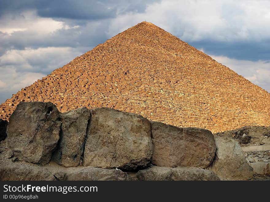 Scene of the egyptian pyramid on background cloudy sky