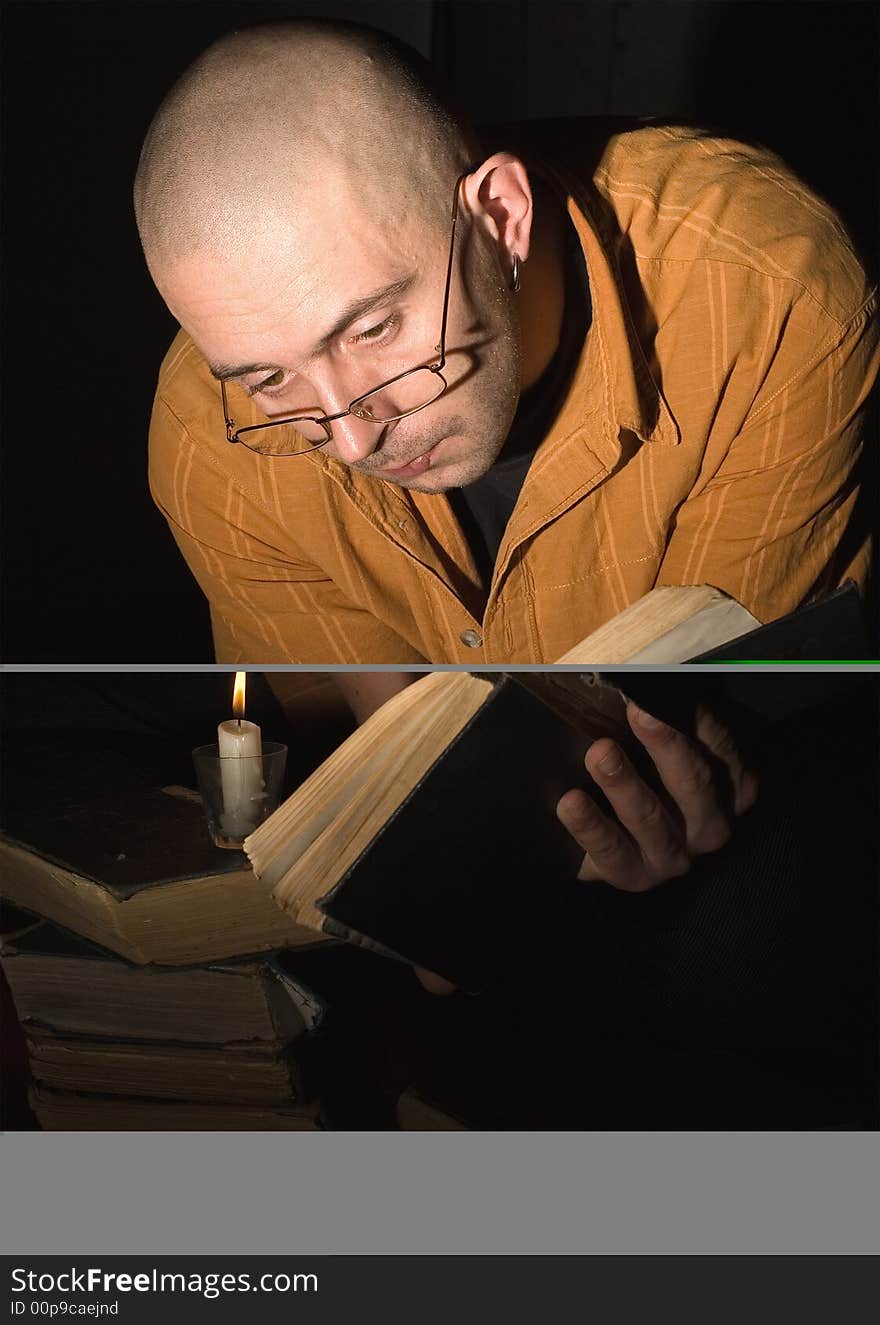 The man reads book above a flame of candle. The man reads book above a flame of candle