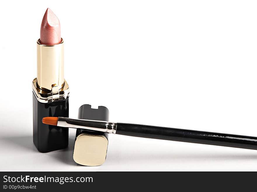 Lipstick and brush on the white background