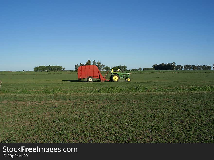 Tractor and rural machine working the land. Tractor and rural machine working the land