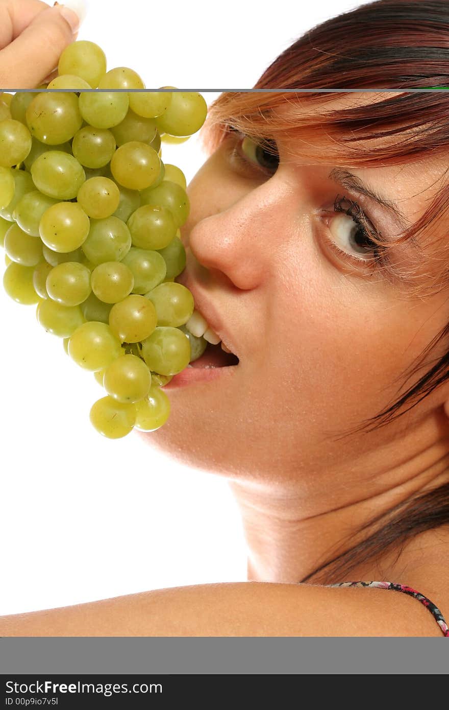 Beautiful girl with green grape on white