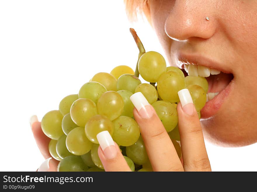 Girl with a cluster of green grapes, isolated on white