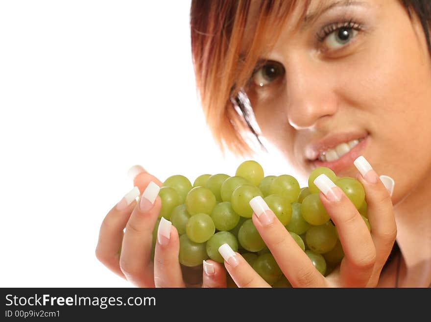 Beautiful girl with green grape on white