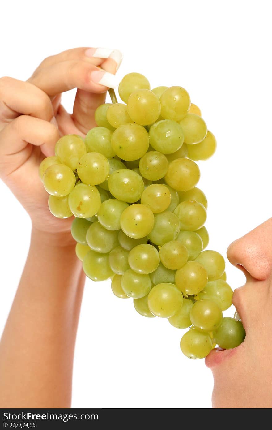 Girl with a cluster of green grapes, isolated on white