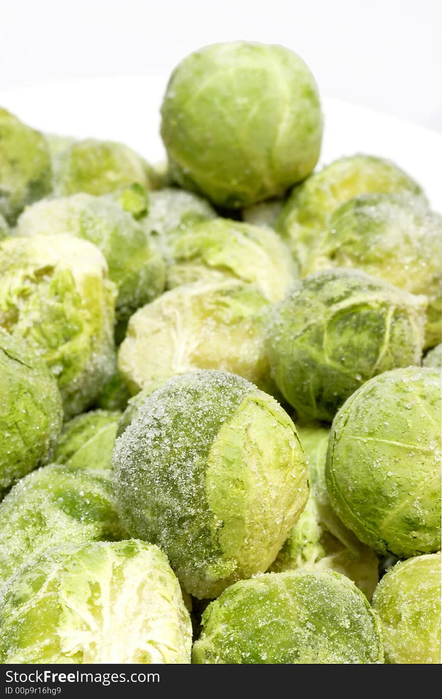 Frozen organic Brussel sprouts on bright background