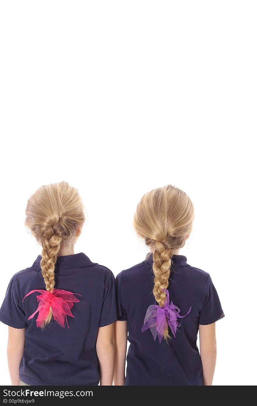 Twin sisters with braided hair isolated on white