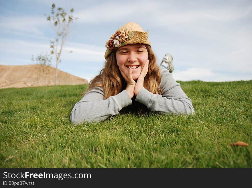 Young girl is enjoying herself in green field