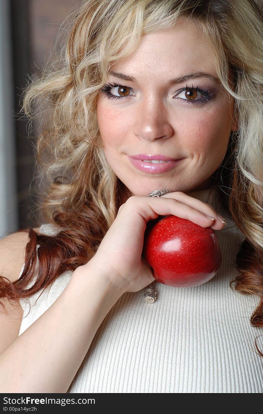 Beautiful woman is holding a fruit in her hands. Beautiful woman is holding a fruit in her hands