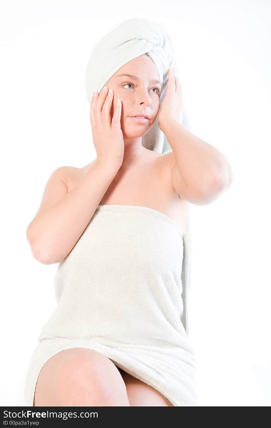 Studio portrait of a spa girl touching the towel on her head. Studio portrait of a spa girl touching the towel on her head