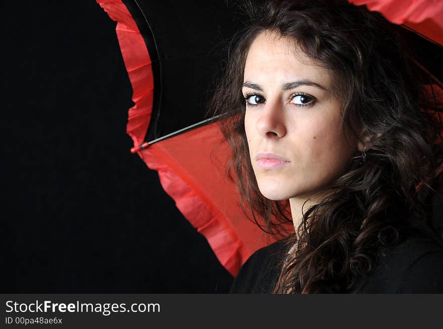 Beautiful brunette with umbrella on black background. Beautiful brunette with umbrella on black background