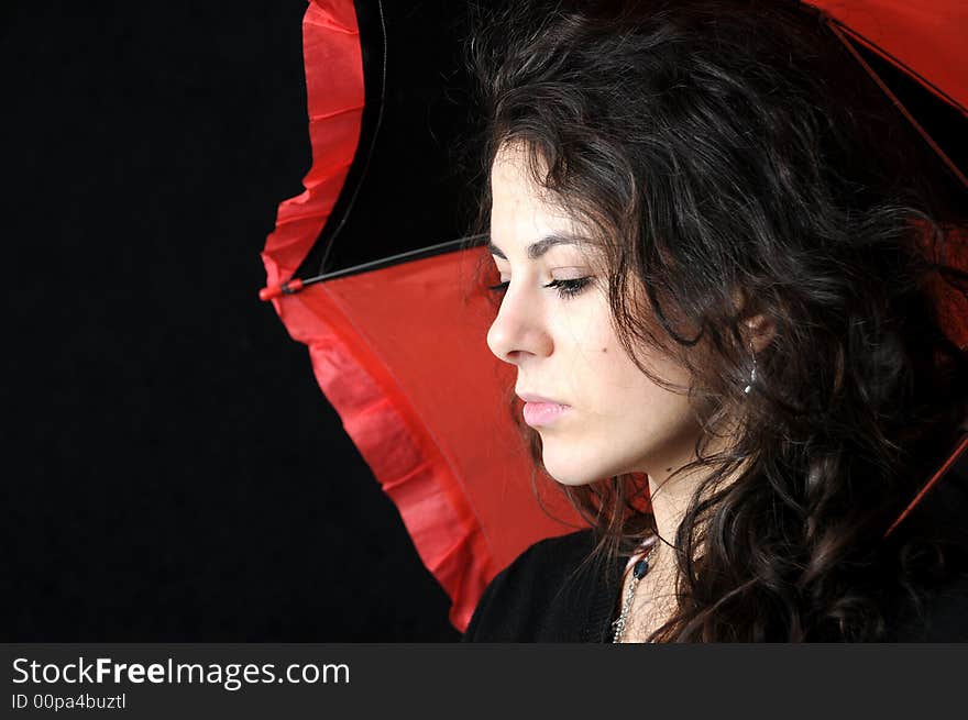 Beautiful brunette with umbrella on black background. Beautiful brunette with umbrella on black background