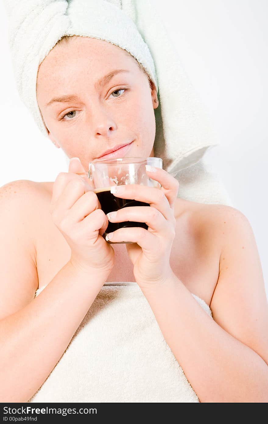 Studio portrait of a spa girl drinking coffee and waking up. Studio portrait of a spa girl drinking coffee and waking up