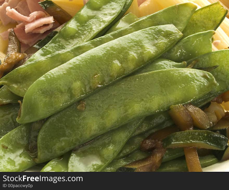 Closeup of boiled green pea pods on a plate. Closeup of boiled green pea pods on a plate