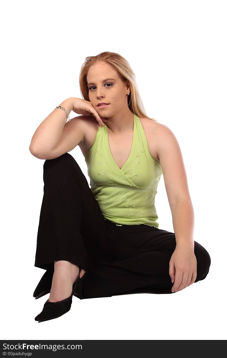 Model sitting on ground with one hand on knee. Model sitting on ground with one hand on knee