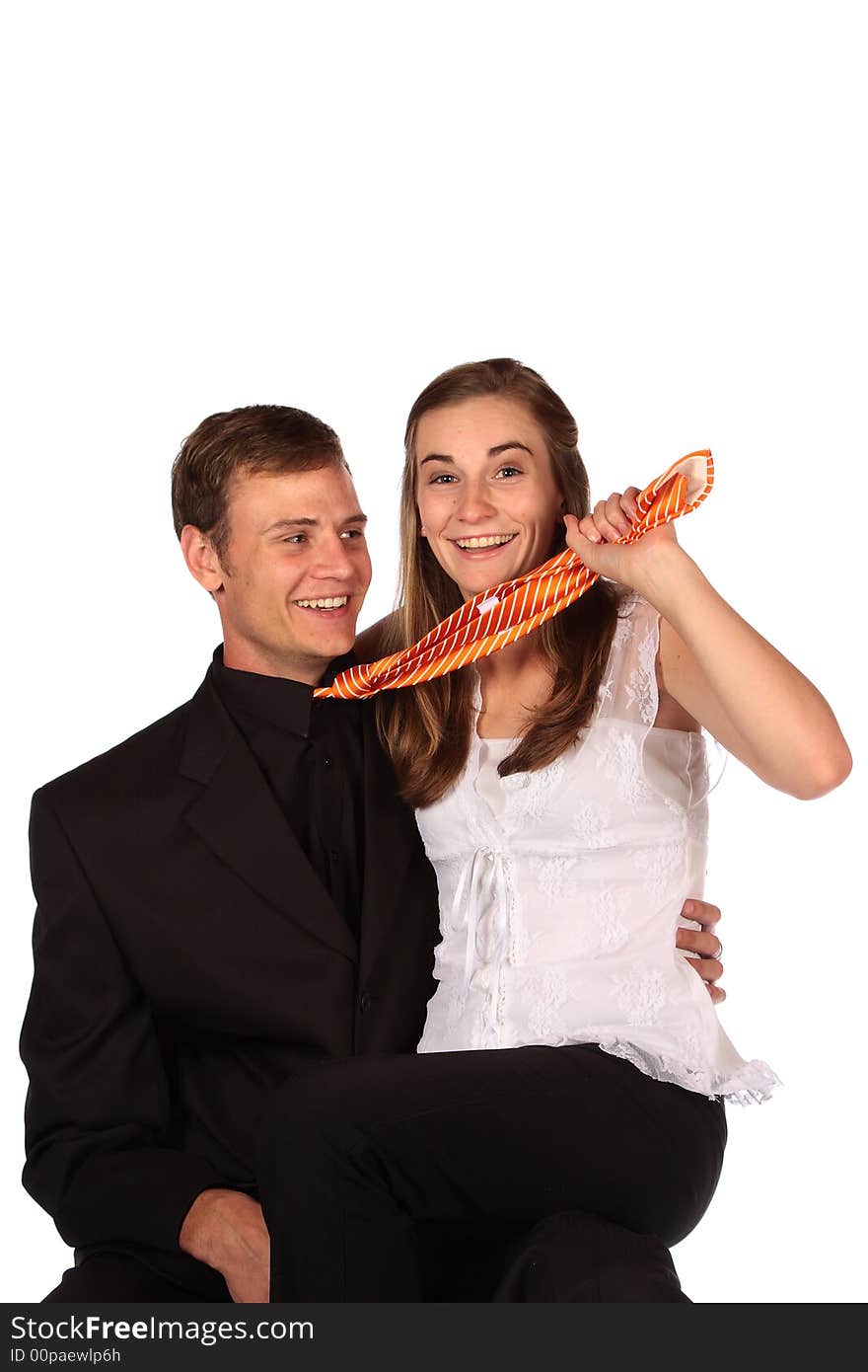 Girl playfulle pulling her partner's orange tie