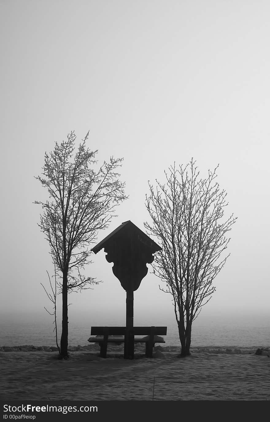 Winter meditation in bavaria, trees, bench and religious sign