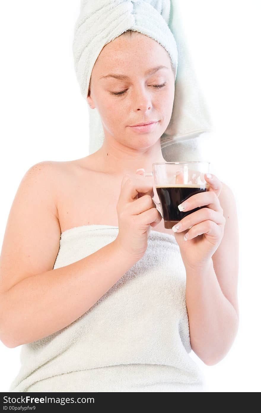 Studio portrait of a spa girl drinking coffee out of a glass. Studio portrait of a spa girl drinking coffee out of a glass