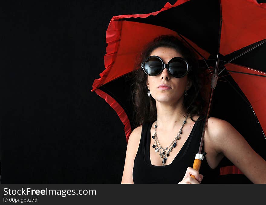 Beautiful brunette with umbrella on black background. Beautiful brunette with umbrella on black background
