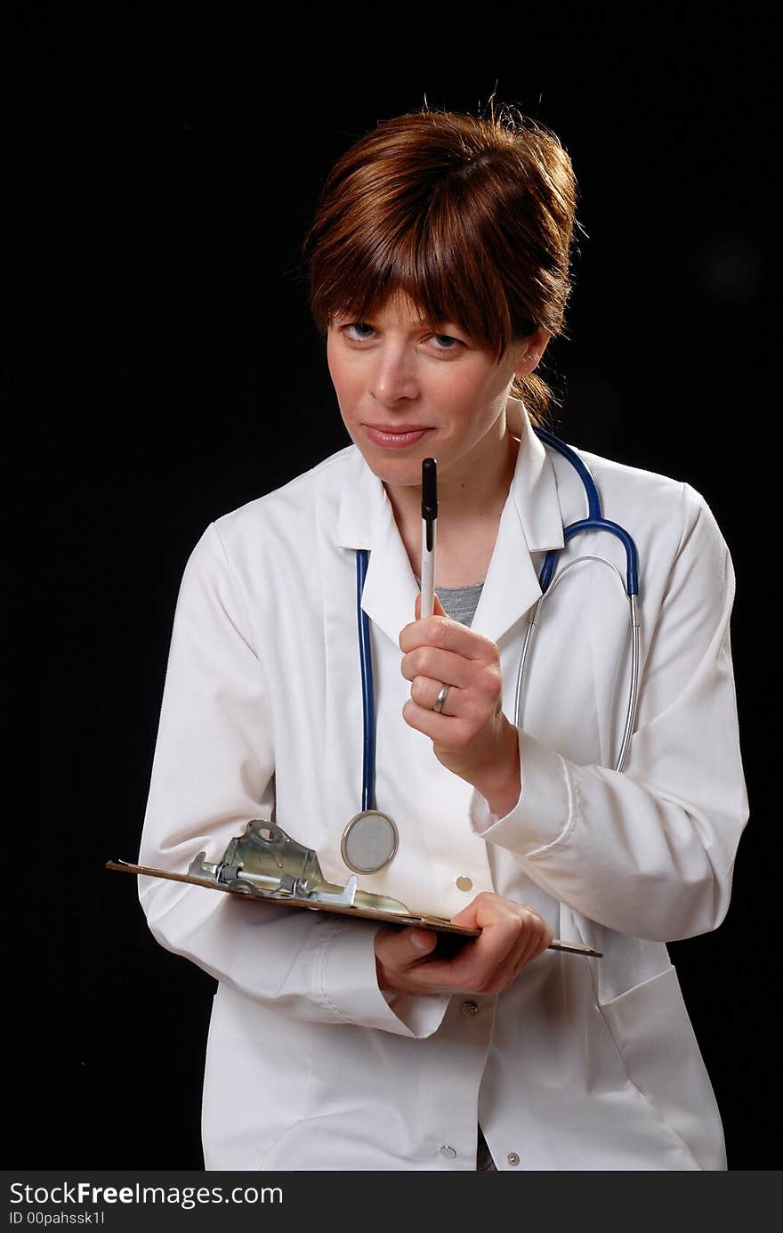 Attractive young lady doctor in white coat with stethosope lecturing a patient - on black background. Attractive young lady doctor in white coat with stethosope lecturing a patient - on black background