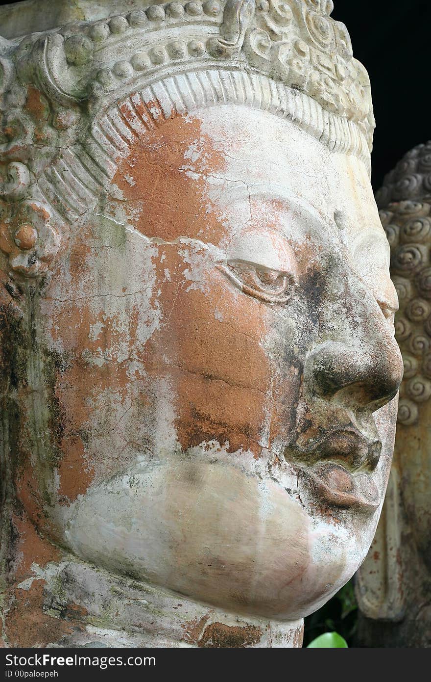 Face of an ancient buddha made of stone.