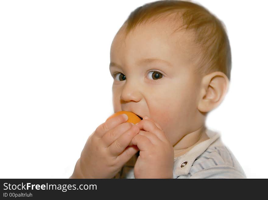 Baby boy eating orange, isolated over white