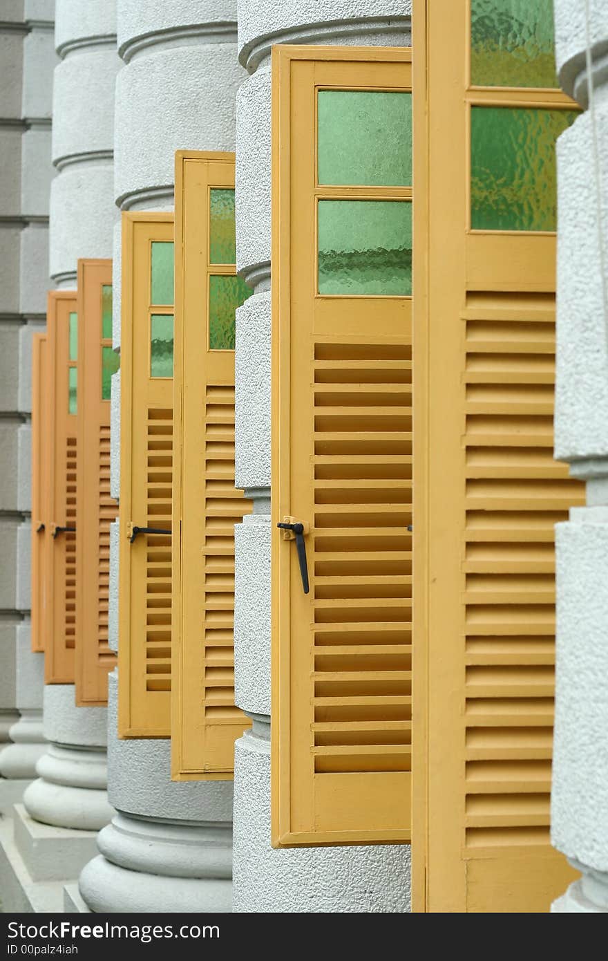 Series of yellow windows from a modern building.