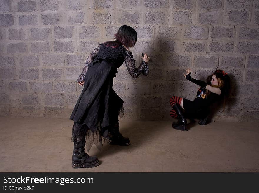 The girl in Gothic style attacks a defenceless victim