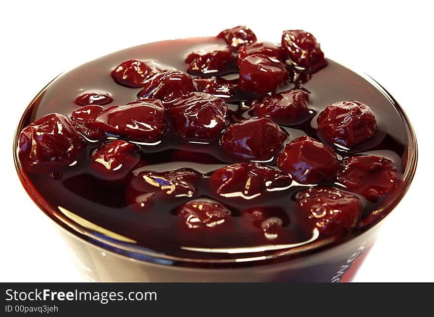 Sweet cherries jam in the transparent glass. Sweet cherries jam in the transparent glass