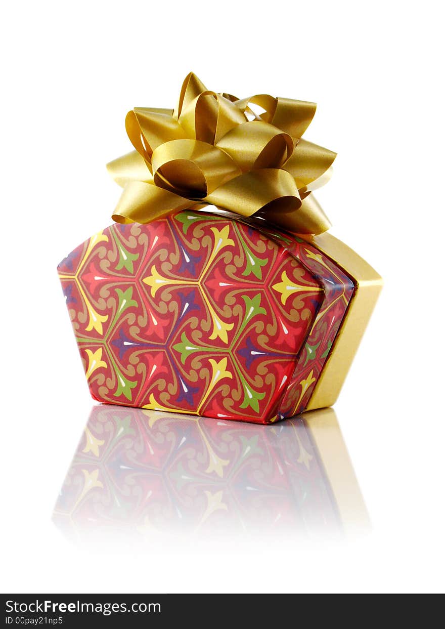 Fancy gift box with gold bow; Isolated with reflection. Fancy gift box with gold bow; Isolated with reflection