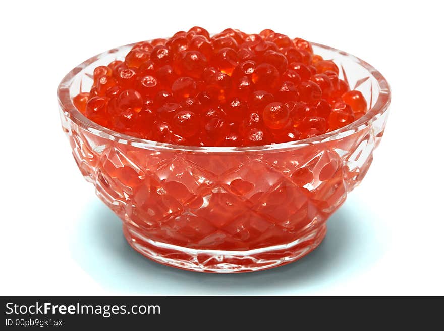 Crystal dish with red caviar on a white background